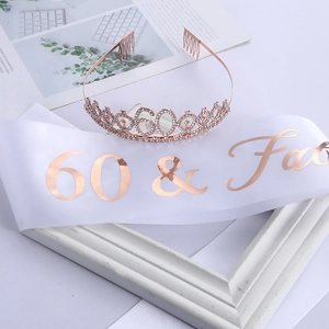 Detail of rose gold 60th birthday crown with rhinestones and 60 & Fabulous white satin sash