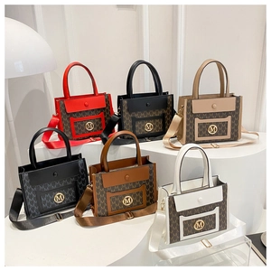 Detailed view of stylish monogram tote bags in multiple colors with metallic M logo buckles