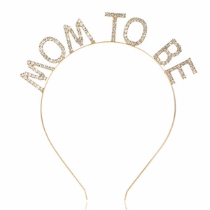 Detail view of Mom To Be headband with sparkling rhinestones on golden metal for baby shower