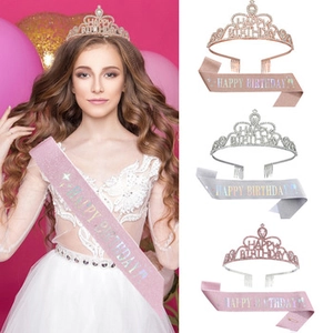 Close-up of sparkling rhinestone tiara and glitter sash for birthday party decorations