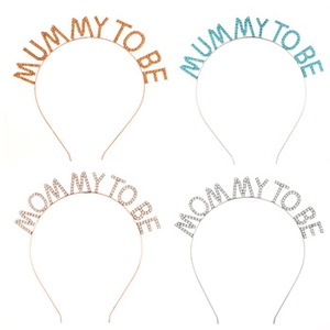 Detail of four metallic Mommy to Be headbands in rose gold, blue, gold, and silver colors