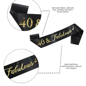 Detail of black and gold 40 & Fabulous birthday sash made of soft satin fabric