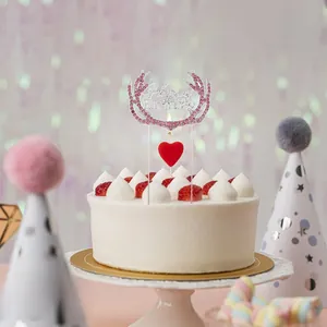 Detail of pink rhinestone deer antler Happy Birthday cake topper with red heart candle