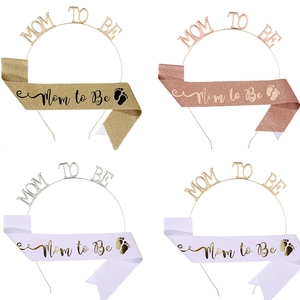 Detail showing four sets of Mommy to Be headbands and glitter sashes in various colors