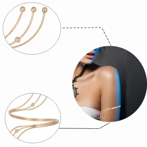 Detailed view of layered gold coil arm cuff featuring smooth metallic ball ends