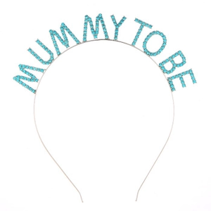 Detail of silver tiara featuring Mummy To Be lettering in light blue rhinestones