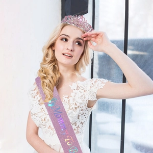Nahaufnahme der rosa Mommy To Be Schärpe und Kristallkrone für die Babyparty