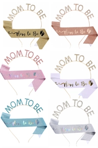 Selection of Mom to Be sashes and rhinestone headbands in various glitter colors