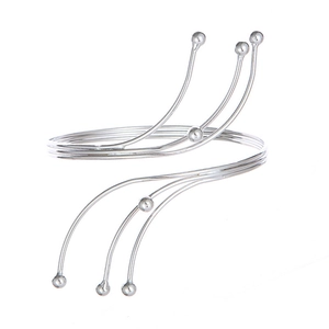 Detail of silver multi-layer spiral arm cuff featuring polished spherical end beads