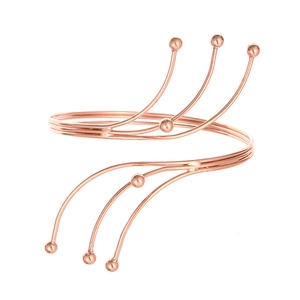 Modern rose gold multi-layered spiral arm cuff with delicate metal beads at the ends