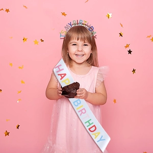 Girl wearing rainbow rhinestone It's My Birthday headband and Happy Birthday sash set