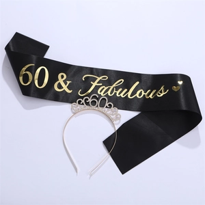 Close-up of 60 & Fabulous black satin sash and silver rhinestone crown for 60th birthday