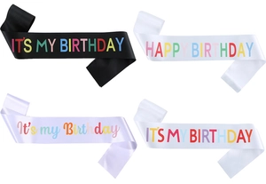 Detail of colorful birthday sashes in black, white and lilac satin for party girl
