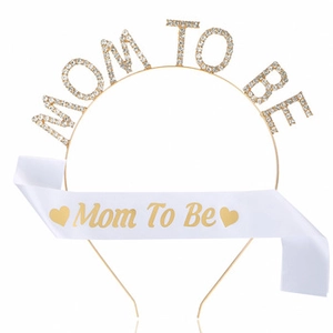 Detail of white satin sash and gold rhinestone Mommy to be headband for baby showers
