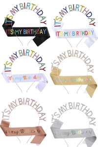 Close-up of birthday party set featuring rhinestone tiara and six colorful satin sashes