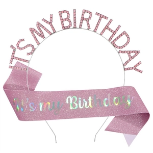 Close-up of pink rhinestone birthday headband and glitter sash party accessory set