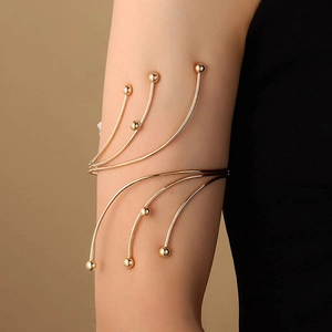 Elegant gold multi-layer sun arm cuff with radial curved lines and bead details