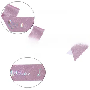 Close-up of Mommy To Be glitter sash with purple fabric and laser iridescent lettering