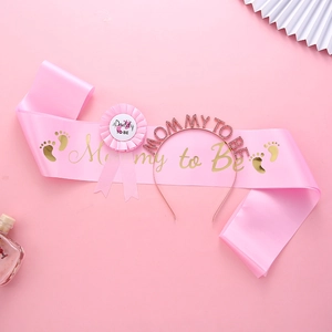 Baby shower set with pink Mommy to Be sash, rhinestone headband, and Daddy to Be badge
