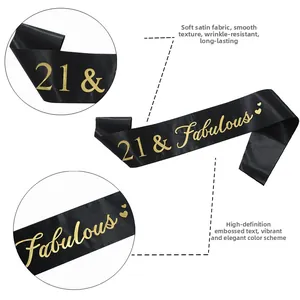 Detail of 21 and Fabulous black satin birthday sash with gold heat stamped letters