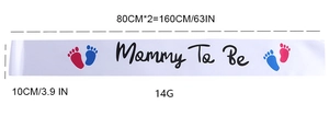 Close-up of white satin Mommy To Be sash with gold foil lettering and footprint detail