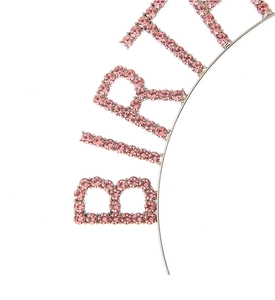 Close-up of pink rhinestones on a metal birthday headband featuring detailed craftsmanship
