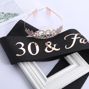 Close-up of 30 & Fabulous rose gold lettering on black satin sash with rhinestone crown