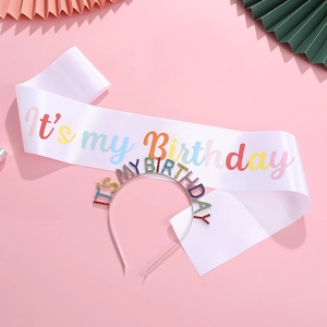Detail of white satin sash and silver rhinestone headband for birthday party set