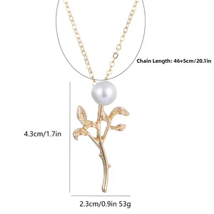Detail shot of golden leaf pendant with natural pearl showing dimensions and weight
