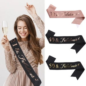 Detail of pink and black glitter sashes featuring gold foil 21 & Fabulous text