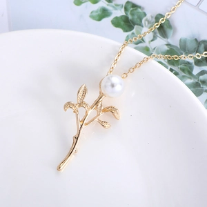 Elegant gold leaf stem pendant with white pearl on a long necklace for women