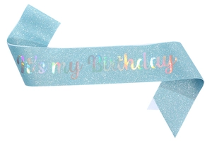 Macro shot of light blue glitter birthday sash with iridescent It's my Birthday text