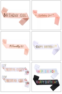 Detail of satin birthday sashes with Birthday Queen and Birthday Girl metallic prints