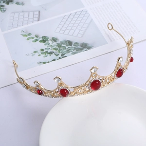Baroque gold crown tiara for brides featuring large red gems and sparkly white rhinestones