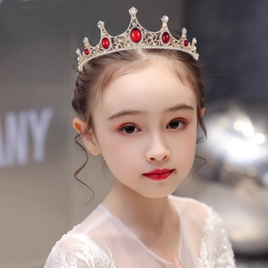 Close-up of vintage Baroque gold crown with red rhinestones for wedding hairstyles