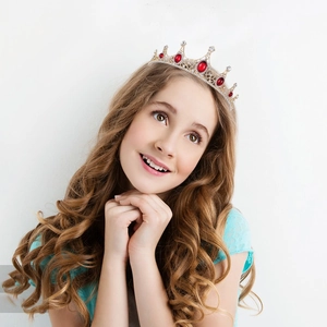 Baroque gold crown with red rhinestones on a young model for weddings or parties