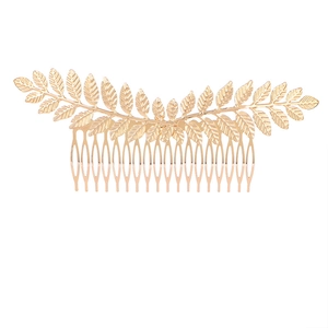 Vintage golden leaf metal hair comb accessory for bridal hairstyles on white background