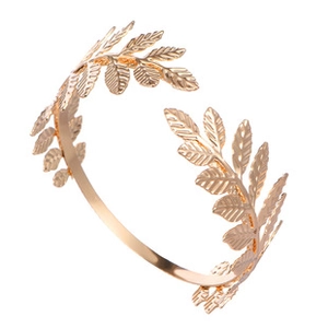 Detail shot of golden laurel leaf metal arm cuff with delicate embossed leaf texture