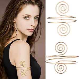 Adjustable gold spiral arm cuff with Greek style texture shown on model and white background