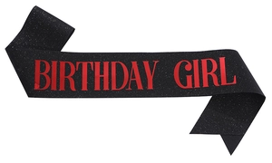 Close-up of black glitter birthday sash with bold red Birthday Girl text details
