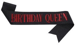 Detail of black glitter Birthday Queen sash with red foil lettering for party decor