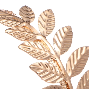 Macro shot of golden leaf bracelet showing realistic vein texture and metallic finish