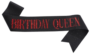 Detail view of black glitter sash featuring red metallic Birthday Queen lettering