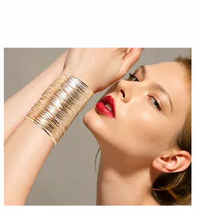 Detail of a wide multi-layer wire-wrapped metallic cuff bracelet in gold and silver