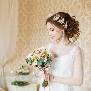 Elegant gold leaf bridal headband set with long tassel earrings for wedding hair styling