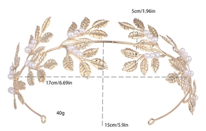 Detail showing dimensions of gold leaf bridal tiara with pearls on a plain white background