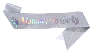 Detail of silver glitter Mommy To Be sash with laser reflective lettering for baby shower