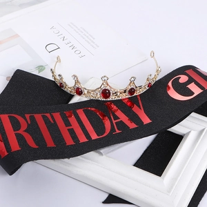 Detail of gold crystal crown with red gemstones and black Birthday Girl sash set