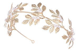 Macro detail of golden leaf-shaped bridal headpiece with elegant pearl embellishments