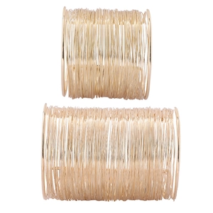 Detailed view of layered gold-tone wire wrap cuff bracelets in a multi-strand design